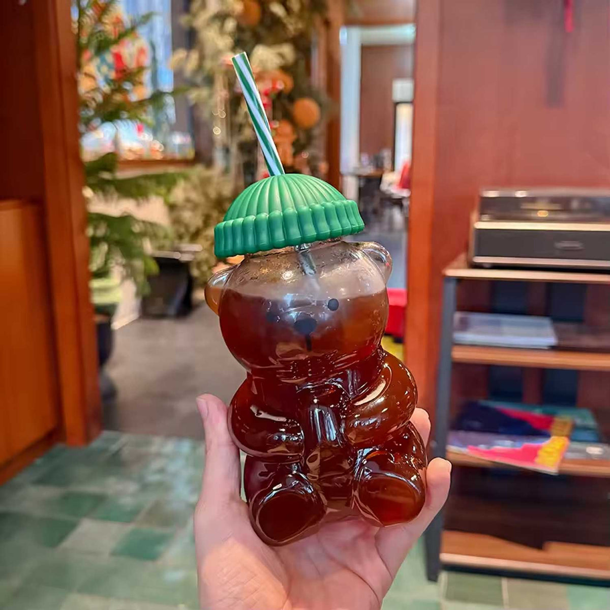 Reusable drinking straw and top hat style lid on bear glass cup