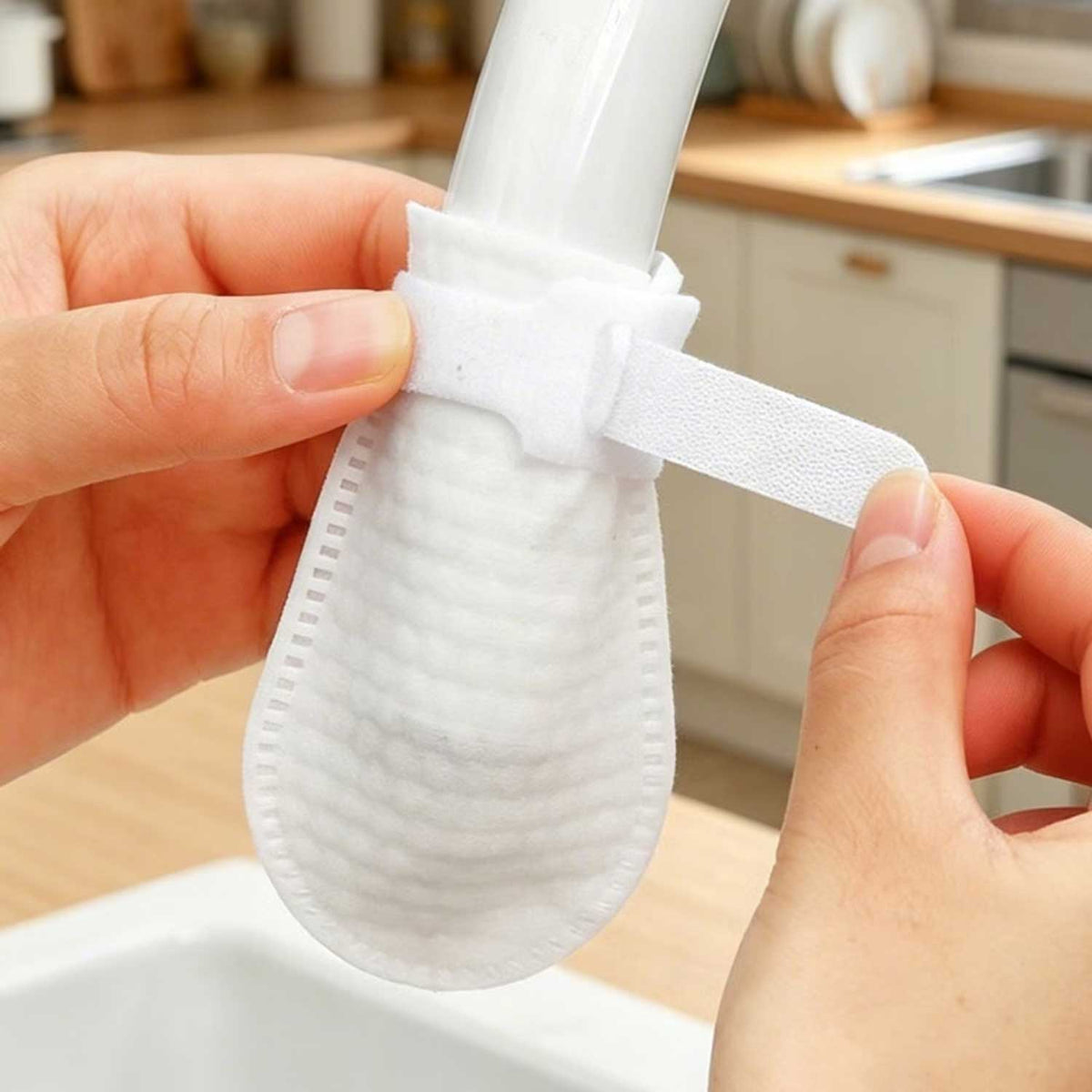 Cotton faucet filter cover fitted over a kitchen tap outlet