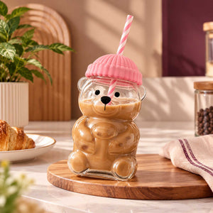 Cute bear glass sipper filled with a cold beverage on a kitchen table